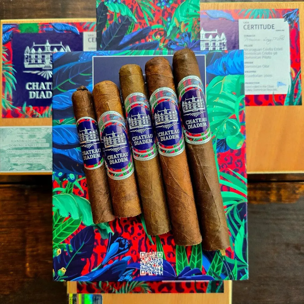 Five Chateau Diadem Certitude cigars fanned across the vibrant Certitude box with Liga Certitude tobacco spec card visible in the background at Smokers Abbey Austin