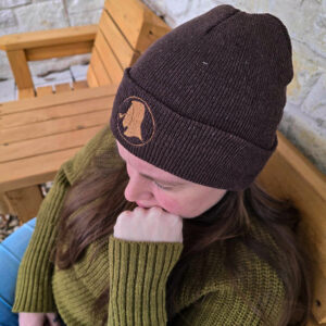 Close-up of Smokers Abbey beanie in brown, featuring the embroidered monk logo.