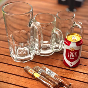 Beer mugs on the table with three cigars and a Lone Star beer