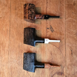 Three Moonshine Patriot Pipes lined up in various finishes and stems