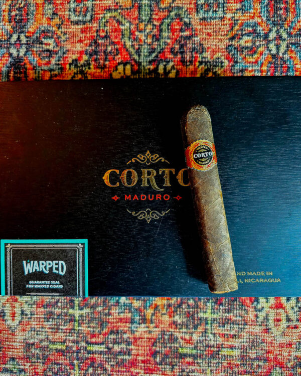 Warped Corro Maduro cigar on the closed box