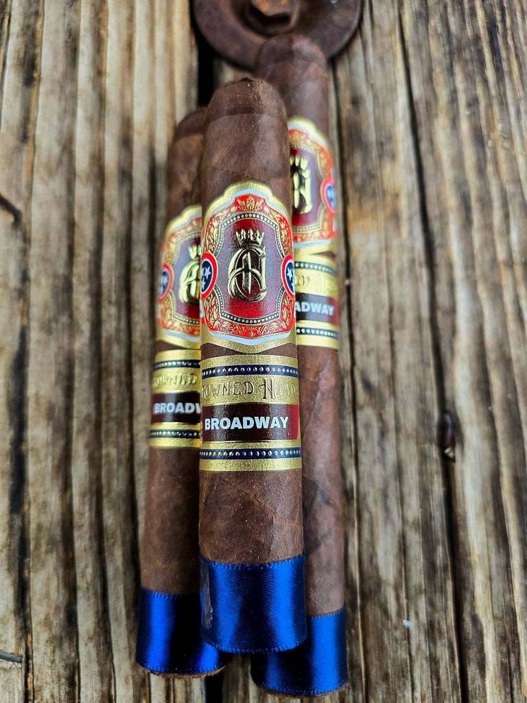 Crowned Heads Broadway cigars in Epicures, Toro and Robusto Extra on wood table