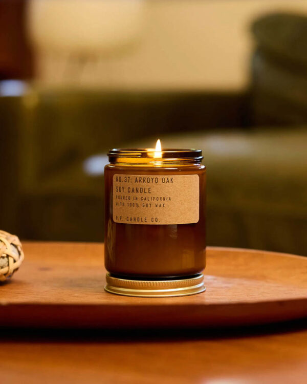 P.F. Candle Co Arroyo Oak candle lit on table