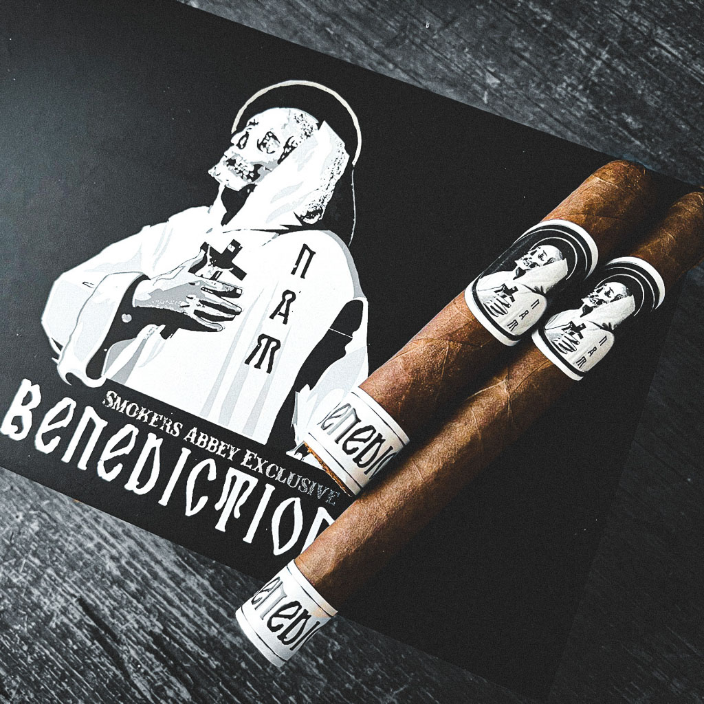 Benediction Robusto and Lonsdale on closed Benediction box on black wood table