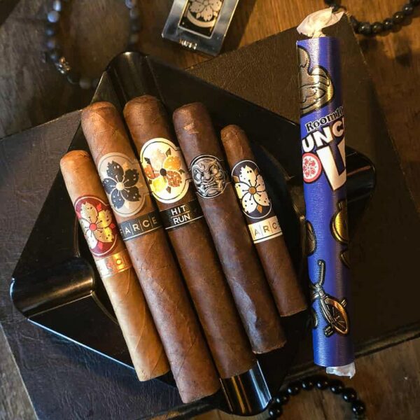 Room 101 cigar sampler with premium cigars arranged on a humidor box