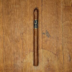 ake Wyatt Lucid Interval Dominican Candela Lancero cigar with black and gold band displayed on rustic wood surface — the last of the discontinued Dominican Candela Lancero vitola at Smokers Abbey Austin