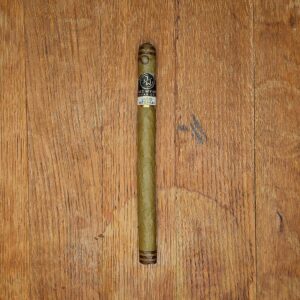 Jake Wyatt Lithium Dominican Lancero cigar with black and gold band displayed on rustic wood surface — the last of the discontinued Dominican Lancero vitola at Smokers Abbey Austin