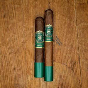 Ozgener Maracana Box Pressed Robusto Extra and Toro cigars displayed side by side on rustic wood surface showing Brazilian Arapiraca wrapper and green and gold OZ Family Cigars Maracana band at Smokers Abbey Austin