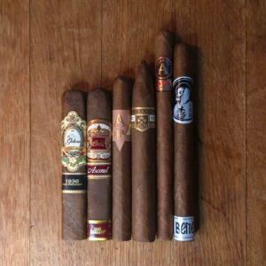 Habano Sampler featuring La Galera 1936 Box Pressed, Casa Carrillo Ascend, Artista Puro Ambar, Rodriguez Series 84, Aladino Classic Elegante, and BLTC Benediction displayed side by side on rustic wood surface at Smokers Abbey Austin