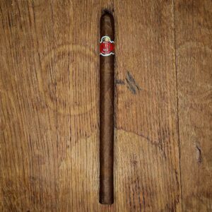 HVC 500 Aniversario Only Legend lancero with red and gold 500th Anniversary band, displayed on rustic wood surface at Smokers Abbey Austin