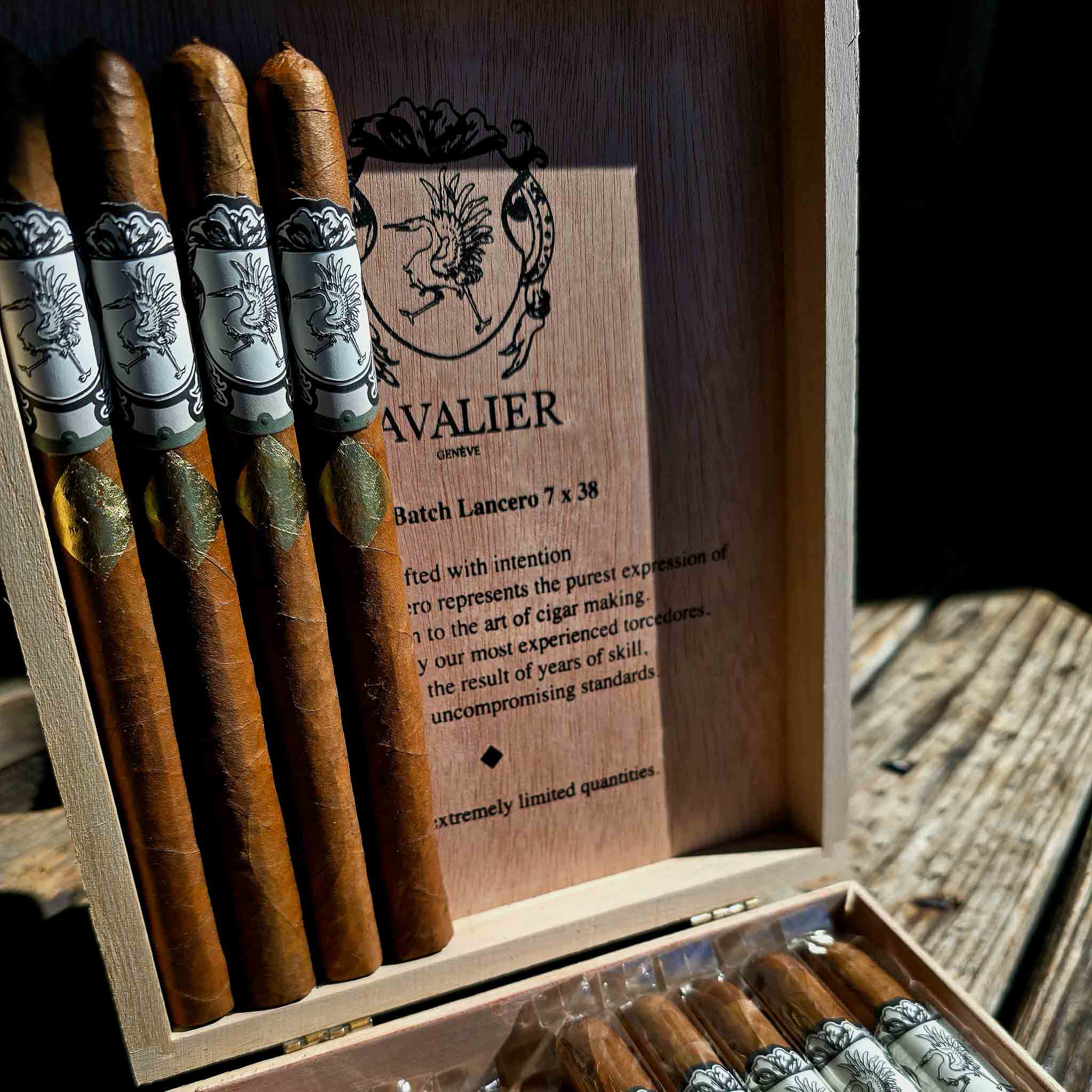Cavalier Genève Small Batch Lancero 7 x 38 cigars standing in an open cedar box with the Cavalier crest on the lid at Smokers Abbey Austin